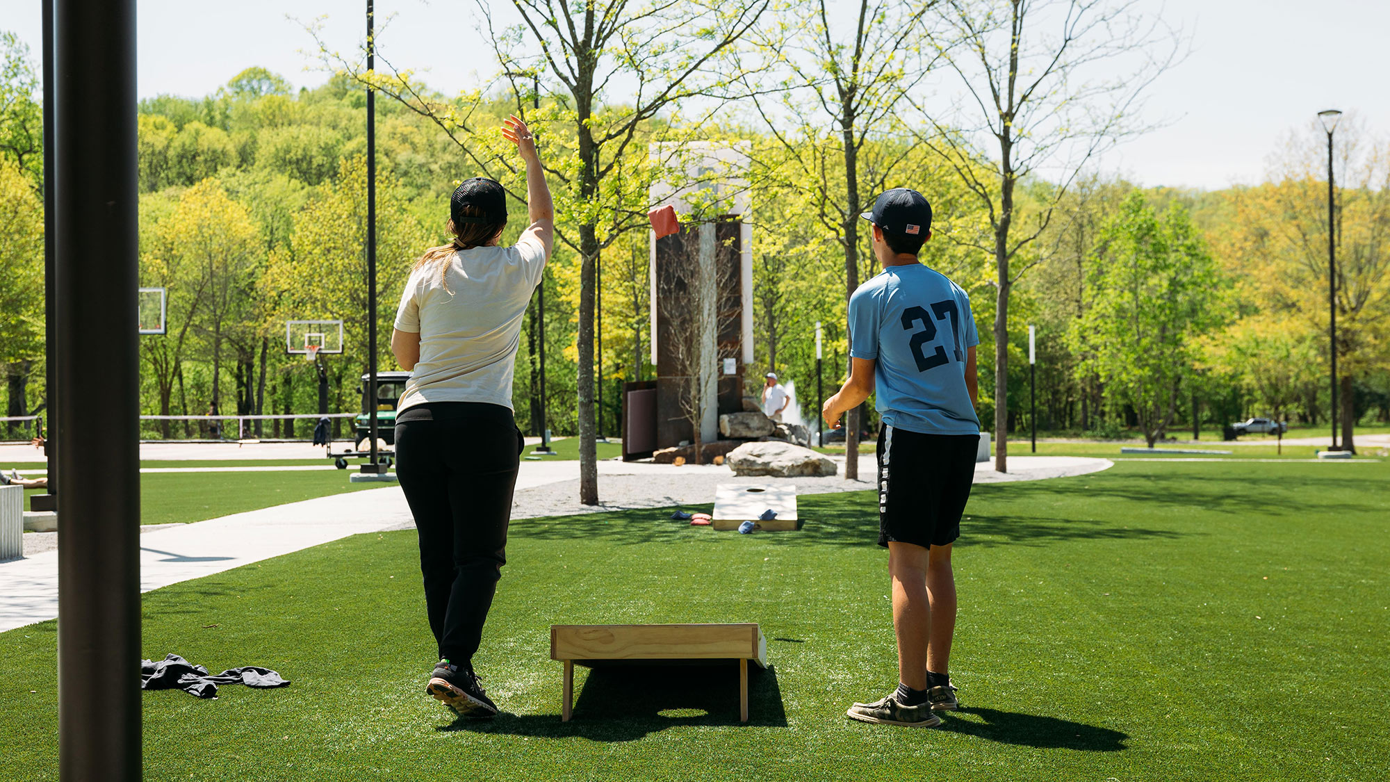 A family enjoying a game of cornhole.